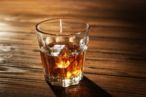 Glass of whisky on wooden table — Stock Photo, Image