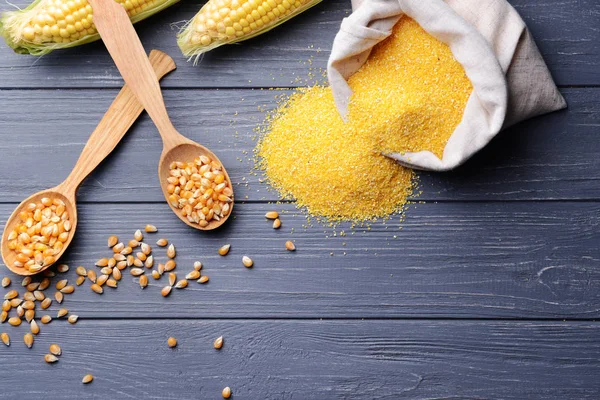 Corn seeds in spoons — Stock Photo, Image