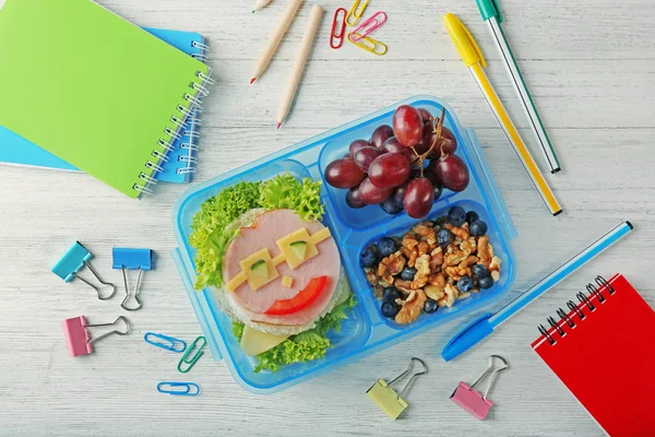 Tasty sandwich and fruits in lunchbox — Stock Photo, Image