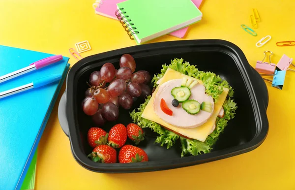 Tasty sandwich and fruits in lunchbox — Stock Photo, Image
