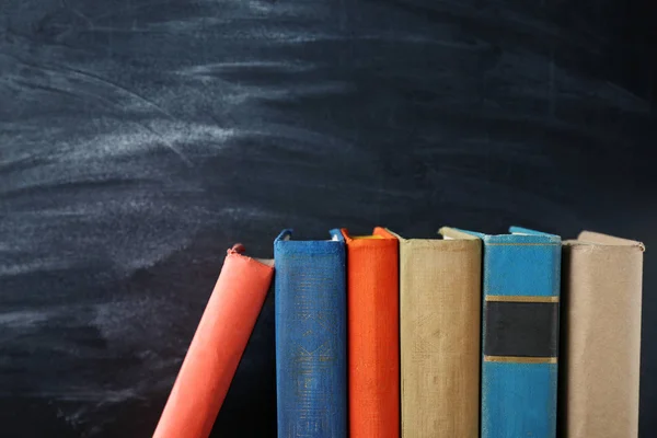 Stacked Books and blackboard — Stock Photo, Image