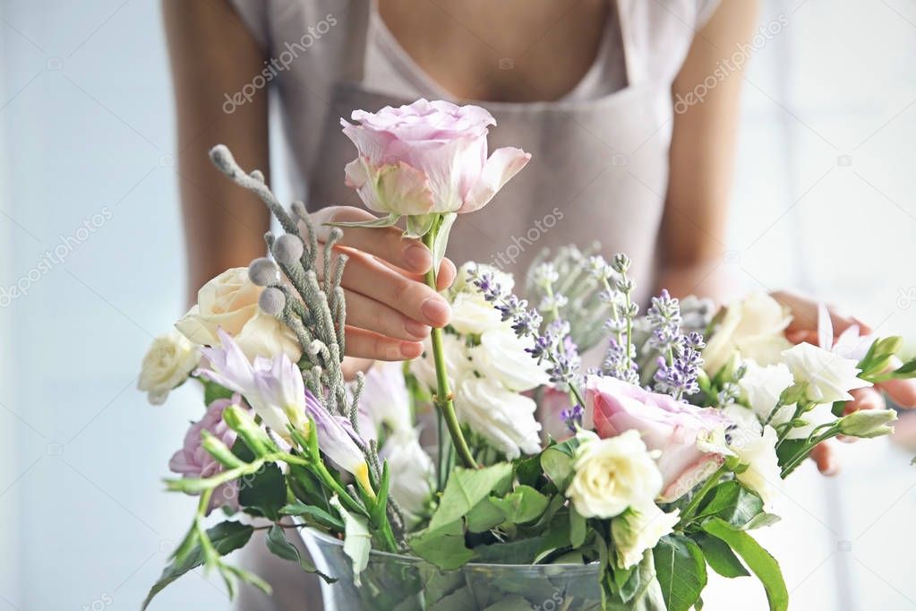 Female florist making beautiful bouquet at flower shop