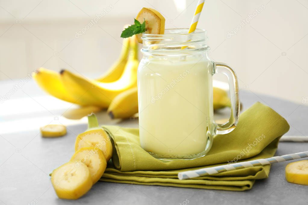 Jug with tasty banana milk shake