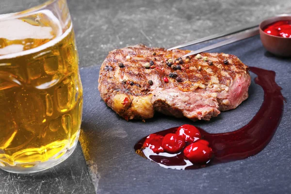 Chutný šťavnatý steak s omáčkou a pivem na břidlicové desky — Stock fotografie