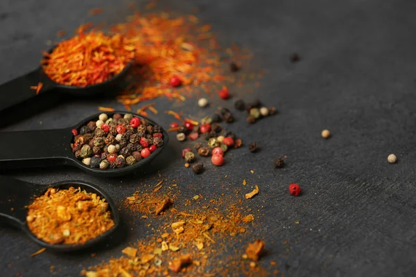 Different spices in spoons on table — Stock Photo, Image