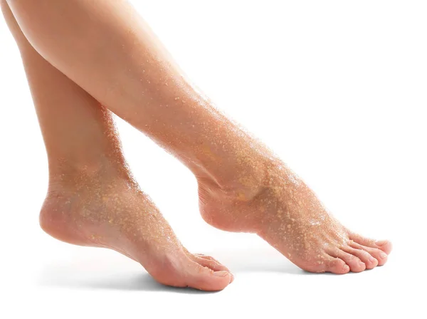 Female feet with scrub isolated on white — Stock Photo, Image