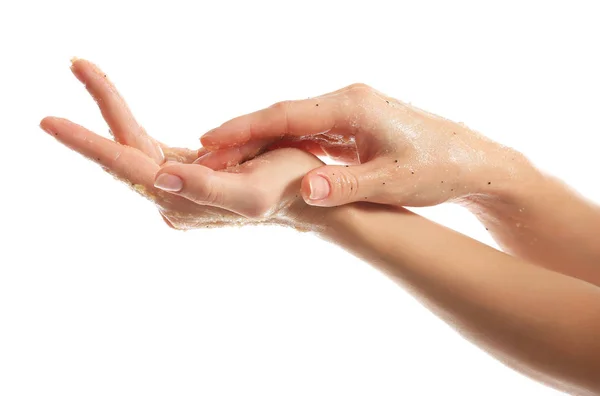 Vrouwelijke handen met scrub op witte achtergrond — Stockfoto