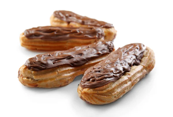 Delicious eclairs with chocolate in a row on white background — Stock Photo, Image