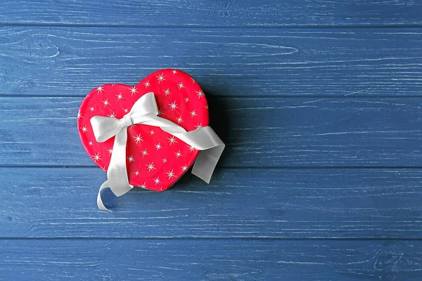 Heart shaped gift box on wooden table — Stock Photo, Image