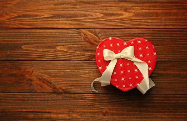 Heart shaped gift box on wooden table — Stock Photo, Image