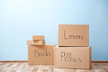 Moving boxes in room on light background