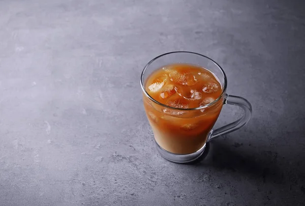 Iced coffee with milk on grey background — Stock Photo, Image