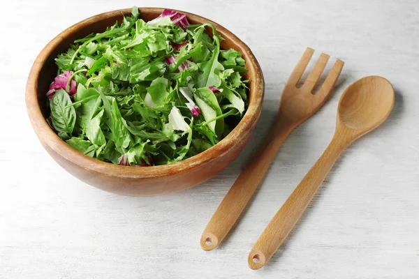 Salad mix in a bowl on wooden table — Stock Photo, Image