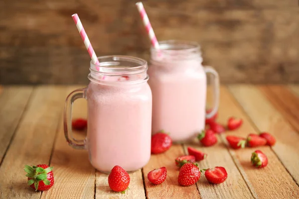 Milkshakes de bagas na mesa de madeira — Fotografia de Stock