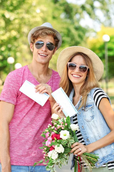 Just married couple holding tickets in park — Stock Photo, Image