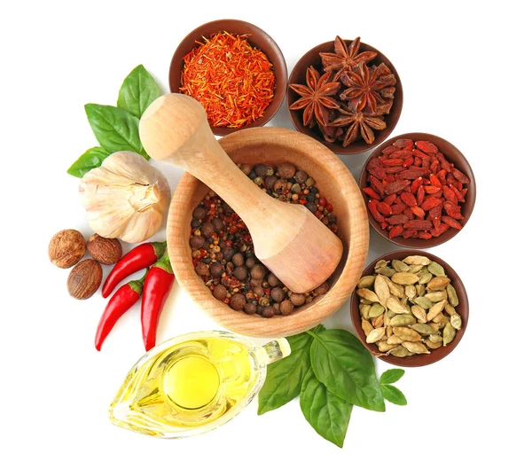 Composition with different spices and mortar on white background — Stock Photo, Image