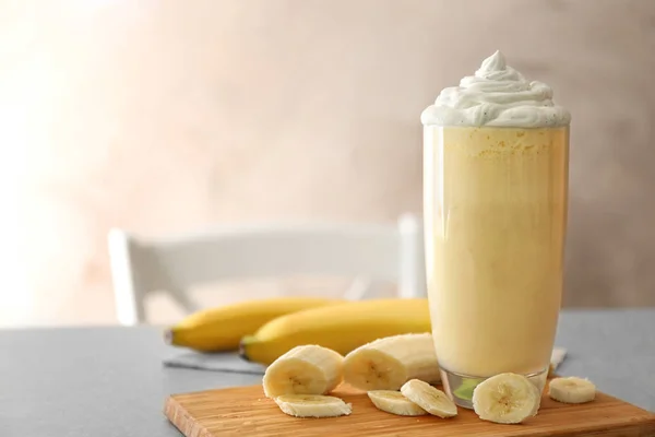 Delicious banana milkshake on table, closeup