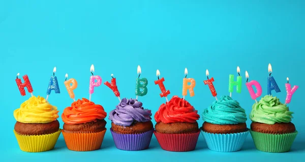 Happy birthday cupcakes on blue background