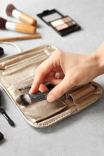 Female makeup artist hand with professional brush at work