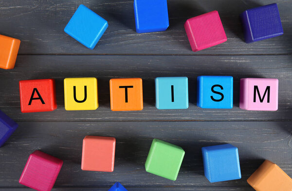Wooden cubes with word AUTISM