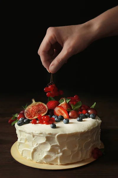 Bäcker Hand dekoriert cremigen Kuchen — Stockfoto