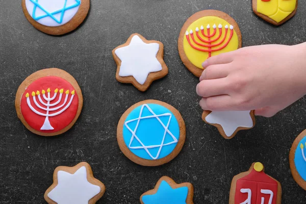 Hand taking tasty cookie for Hanukkah — Stock Photo, Image