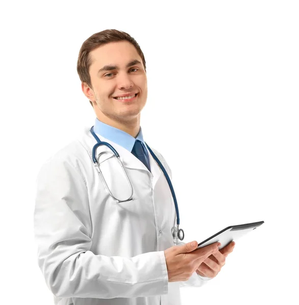 Young male doctor with tablet on white background Royalty Free Stock Images