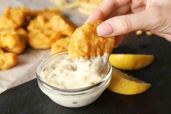 Woman holding tasty nugget — Stock Photo, Image