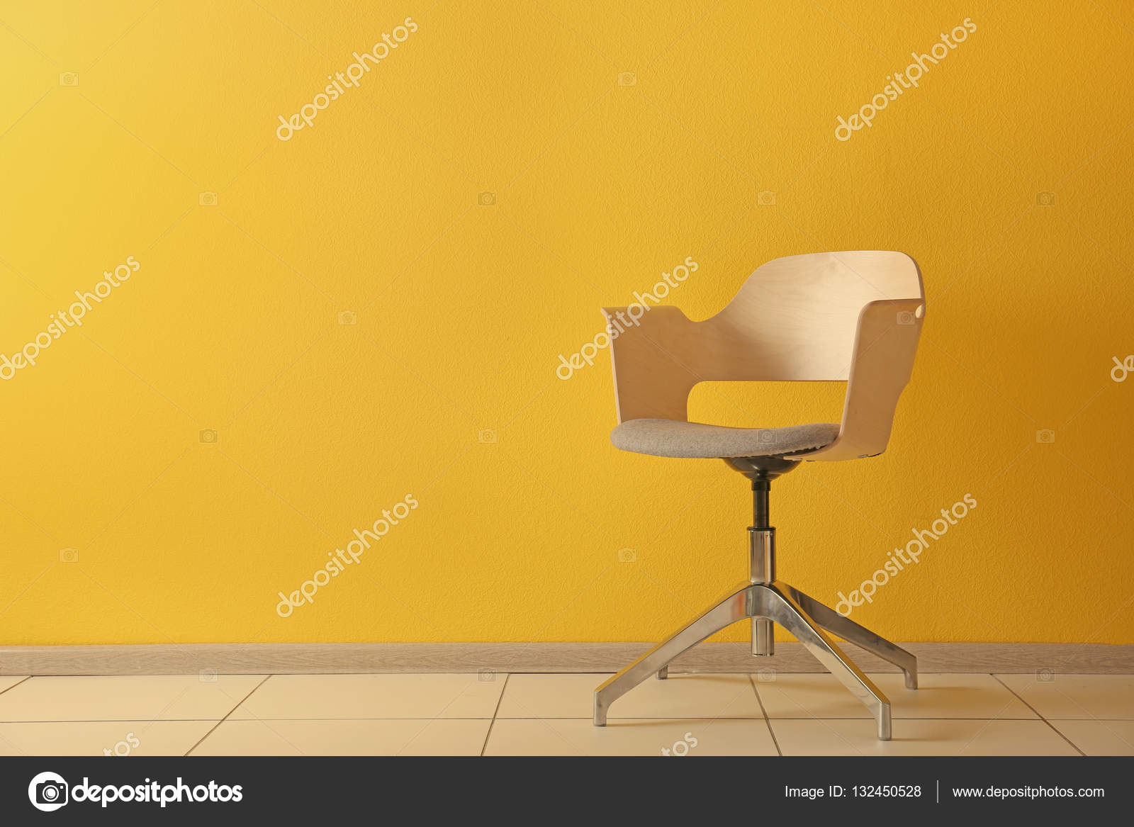 Stylish chair on wall background Stock Photo by ©belchonock 132450528