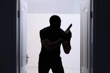 Thief with gun   clipart