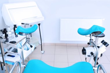 Gynecological room with chair  clipart