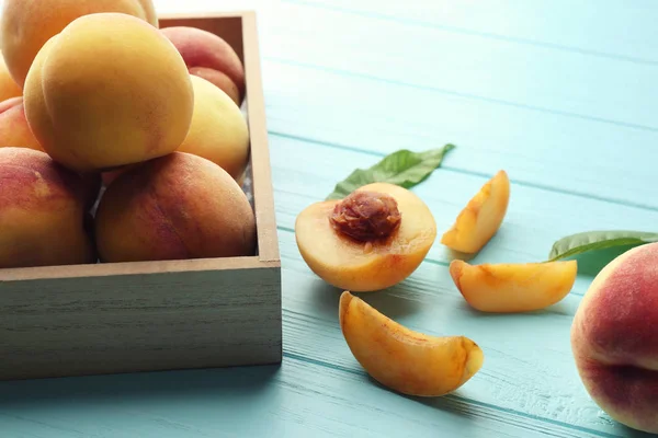 Juicy peaches in wooden box