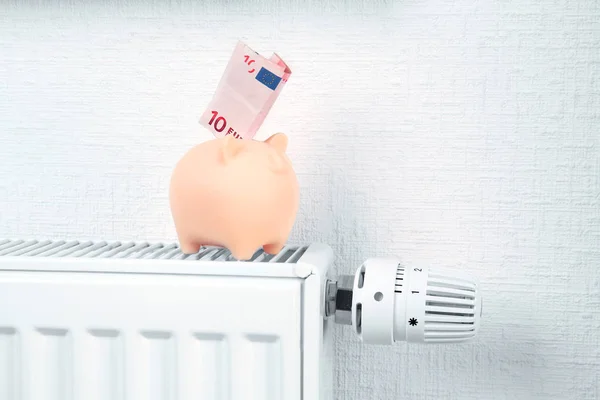 Heating battery with piggy bank — Stock Photo, Image