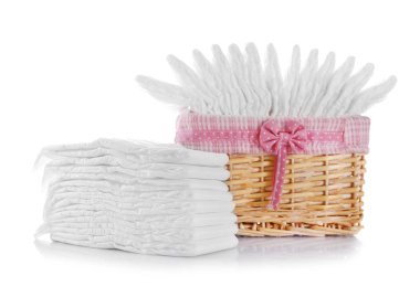 Wicker basket with baby diapers isolated on white clipart