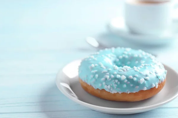 Plate with donut and cup of coffee — Stock Photo, Image