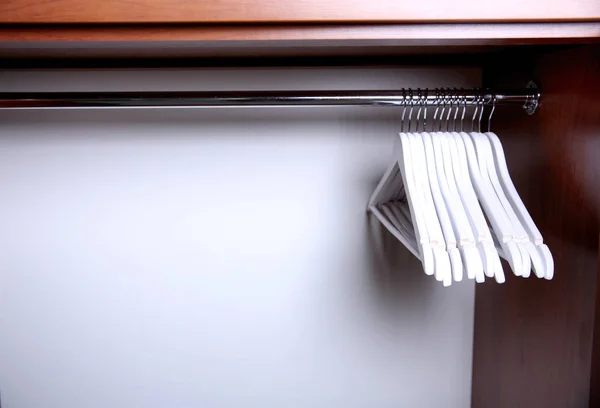 Clothes hangers in empty wardrobe — Stock Photo, Image