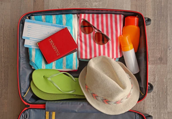 Open suitcase packed for travelling — Stock Photo, Image