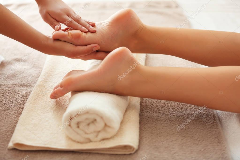 Hands massaging female feet