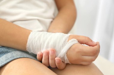  little girl's wrist with  bandage clipart