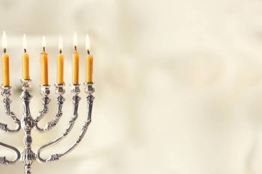 Beautiful menorah with burning candles  clipart
