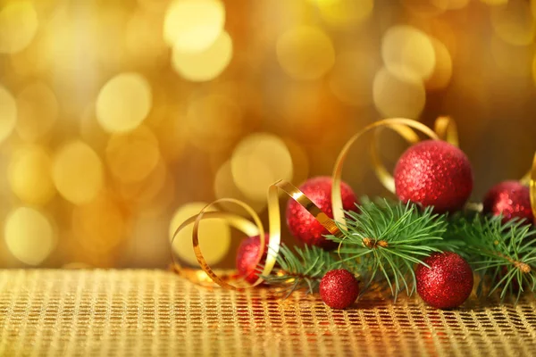 Composition of baubles, ribbon and coniferous branch — Stock Photo, Image