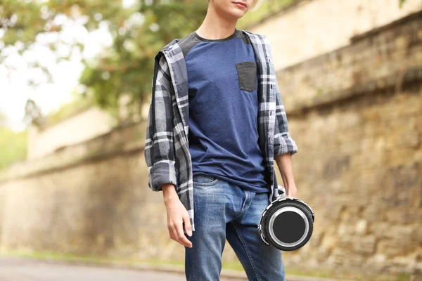 Teenager boy with hoverboard outdoors — Stock Photo, Image