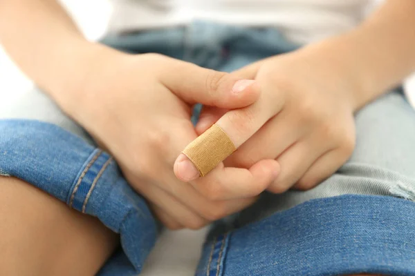 Little boy's finger with  sticking plaster — Stock Photo, Image