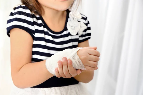 Little girl's wrist with  bandage — Stock Photo, Image