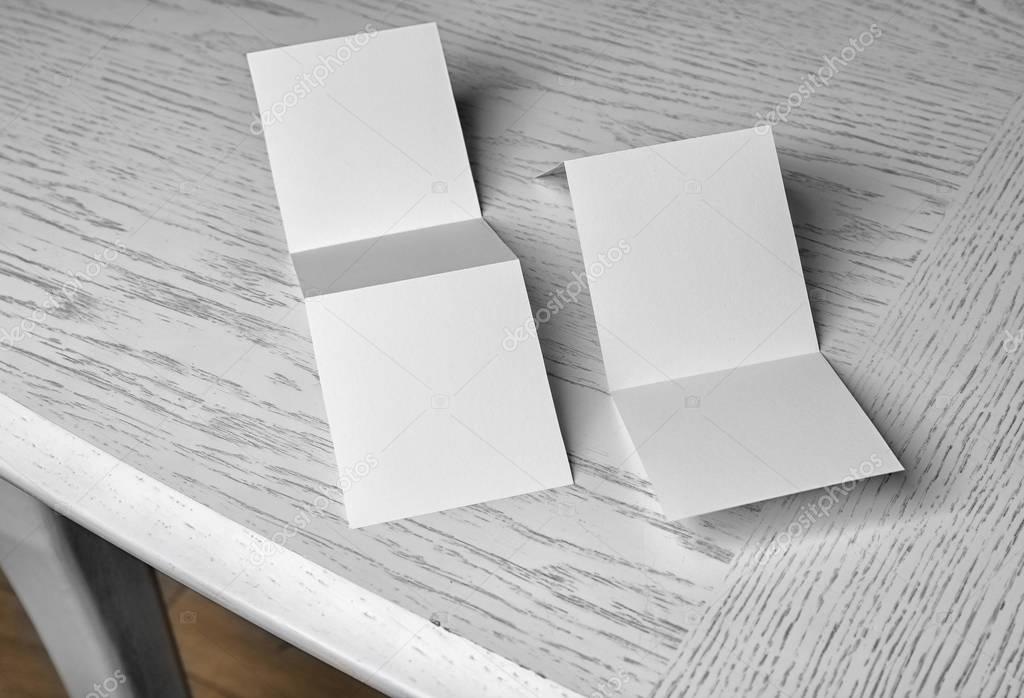 Blank booklets on white wooden table