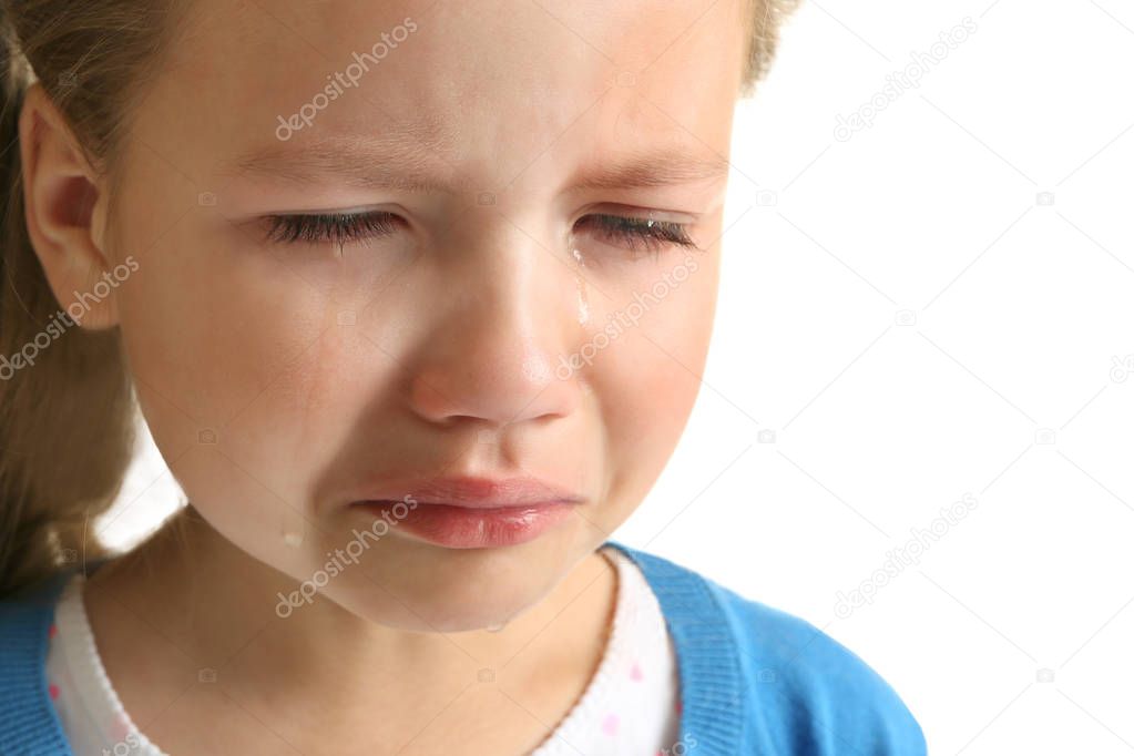 Portrait of crying little girl on white background 