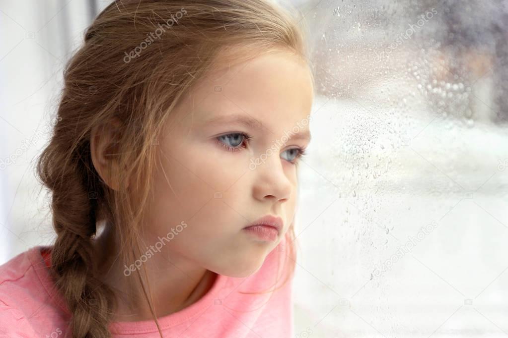  little girl looking out of window