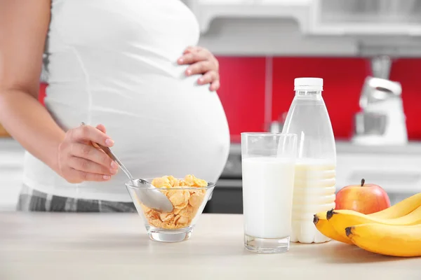 Беременная женщина ест хлопья — стоковое фото