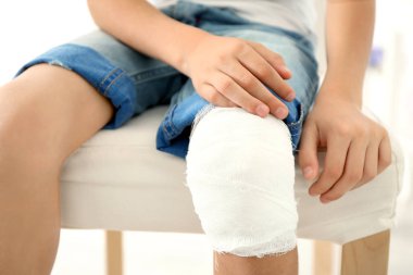 boy's knee with bandage clipart