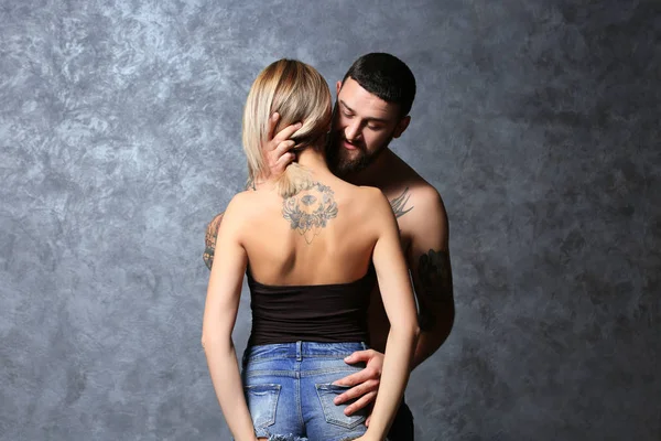 Passion tattooed beautiful couple